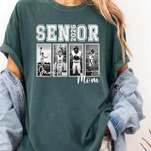 May include: A Blue Spruce t-shirt with the text "SENIOR 2026" in white block letters. Below the text are four black and white images of football players. The word "James" and "Mom" are written below the images.
