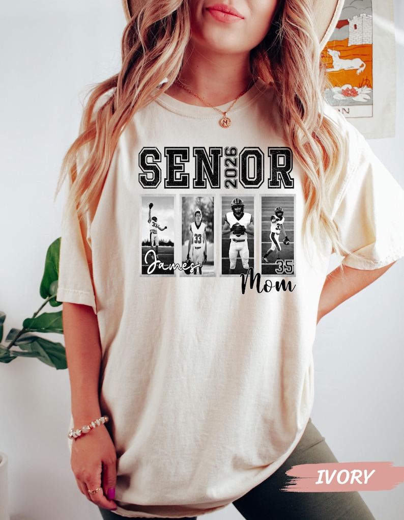 May include: Ivory-colored t-shirt with the text "SENIOR 2026" in black block letters. Below the text are four black and white photos of athletes. The word "Mom" is printed below the photos. The shirt is a relaxed fit.