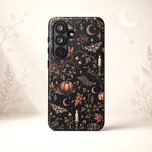 May include: A black smartphone case featuring a detailed pattern of pumpkins, ravens, moths, lit candles, crescent moons, and autumn leaves. The design includes botanical elements and stars scattered across the dark background, with a triple camera lens.