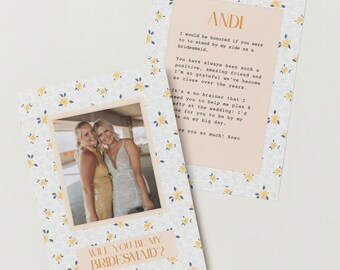 May include: A floral patterned card with a photo of two women smiling. The card asks "Will you be my bridesmaid?" and includes a message to "Andi" about how much the sender appreciates her friendship and wants her to be a bridesmaid.
