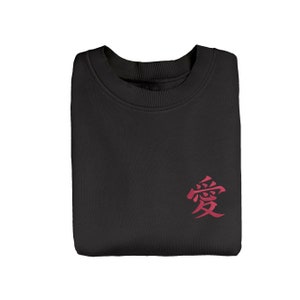 May include: Black sweatshirt with a red embroidered kanji character for "love" on the front.