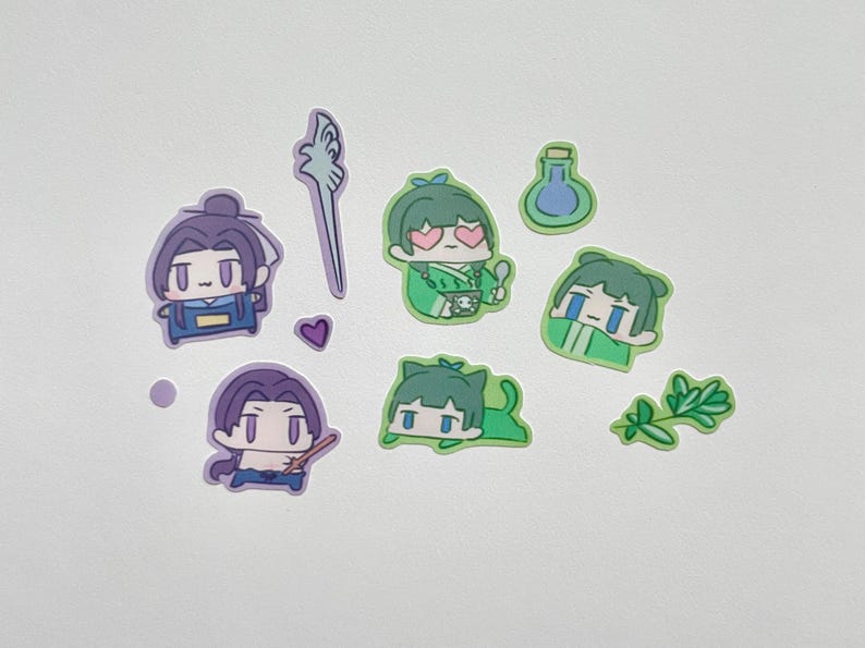 May include: A collection of colorful stickers featuring anime-style characters in various poses. The stickers include figures in green and purple, along with a staff, a heart, and a potion bottle. These stickers are ideal for decorating notebooks, laptops, or other items.