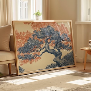 May include: A framed art print depicting a bonsai tree illustration. The artwork features a blue tree set against a peach and cream backdrop. The print is presented in a light wood frame, positioned against a wall in a bright room.