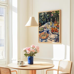 May include: A painting of a table setting with a variety of dishes, including a pizza, fruit, and wine glasses. The painting is framed in a light wood frame and hangs on a white wall.