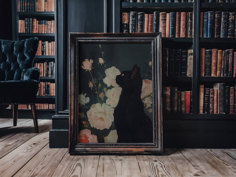 May include: A framed black and white print of a black cat sitting in a field of white roses. The frame is dark brown wood with a decorative border.