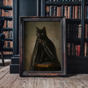 May include: A black cat wearing a black cape with a gold buckle sits on a wooden stool in a framed painting. The painting is set against a dark wood bookshelf with books.