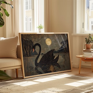 May include: A framed print of a black swan swimming in a dark blue lake under a full moon. The swan is facing left and has a long neck and a black body. The moon is a pale yellow color and is in the upper right corner of the image. The background is a dark blue color with a few trees in the distance.