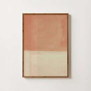 May include: A rectangular wall art piece featuring a two-tone abstract composition. The top half is a solid, muted terracotta orange, while the bottom half is a soft, creamy off-white. The artwork is enclosed in a thin, medium-toned wooden frame.