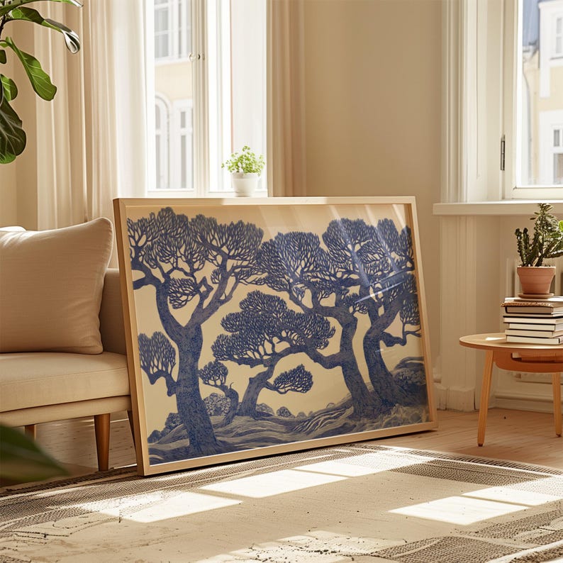 May include: A framed print of a blue and white illustration of three trees with a light brown background.