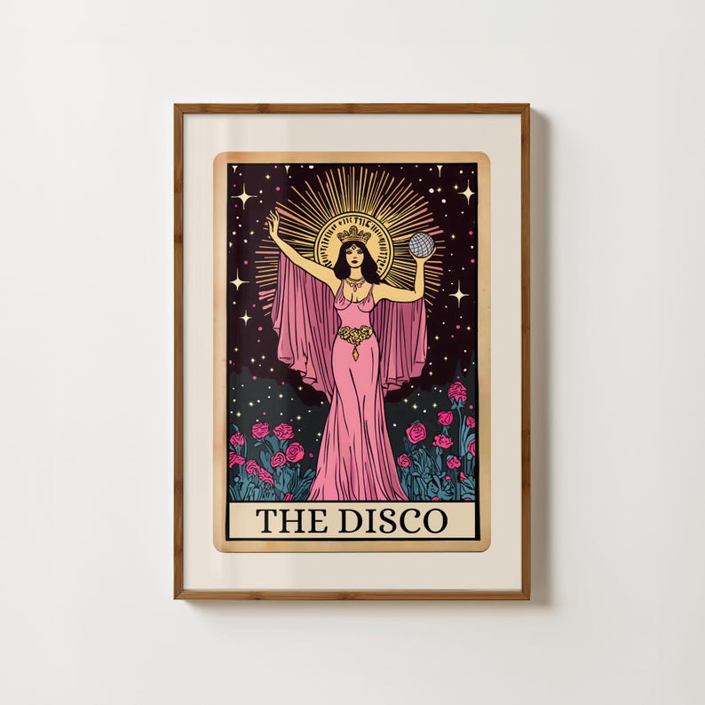 May include: A framed art print featuring a woman in a pink gown, holding a globe, with a halo and a starry background. The words "THE DISCO" are at the bottom. Pink roses are at the bottom of the image.