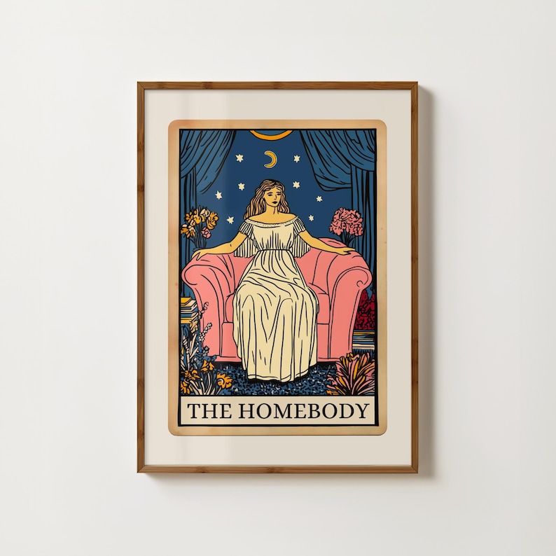May include: A tarot card illustration with a woman sitting on a pink armchair. The card is titled "The Homebody" and features a crescent moon and stars in the background.