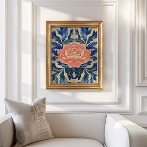 May include: A framed print of a pink flower with blue leaves on a white background. The frame is gold.