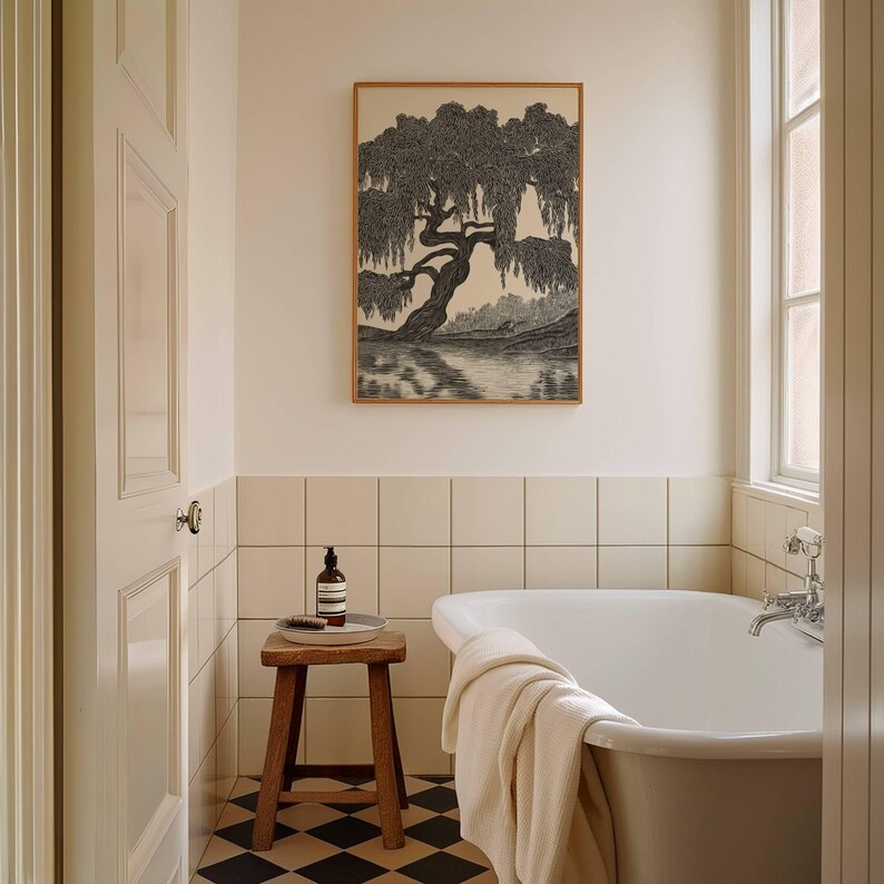 May include: A bathroom scene featuring a framed black and white tree print above a white bathtub. A small wooden stool holds a bottle and a brush. The floor has a black and white checkered pattern.