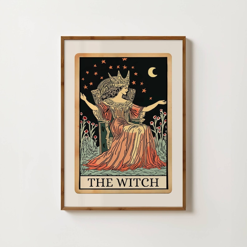 May include: Framed print of a tarot card illustration. The image features a woman wearing a crown, seated on a throne, with a black background filled with stars and a crescent moon. The text "THE WITCH" is at the bottom.
