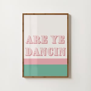 May include: A framed print with a pink and green striped background. The text "ARE YE DANCIN" is in pink with a white outline.