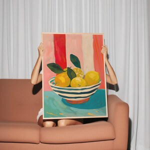 May include: A painting of a bowl of lemons on a blue background. The bowl is white with blue stripes and the lemons are yellow. The background is a pink and red striped pattern.
