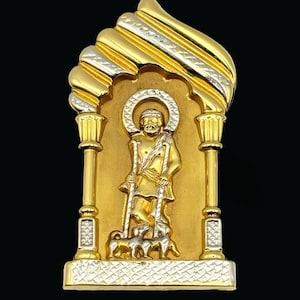 May include: A gold pendant featuring a religious figure holding two staffs, standing in an arched frame. The pendant has a halo and is accompanied by two sheep. The frame and pendant are gold with silver accents.