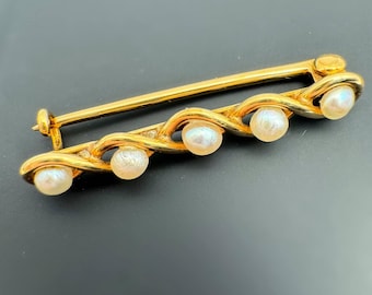 Broche vintage de oro amarillo macizo de 13 k con perla natural de 0,6 quilates y forma de onda infinita.