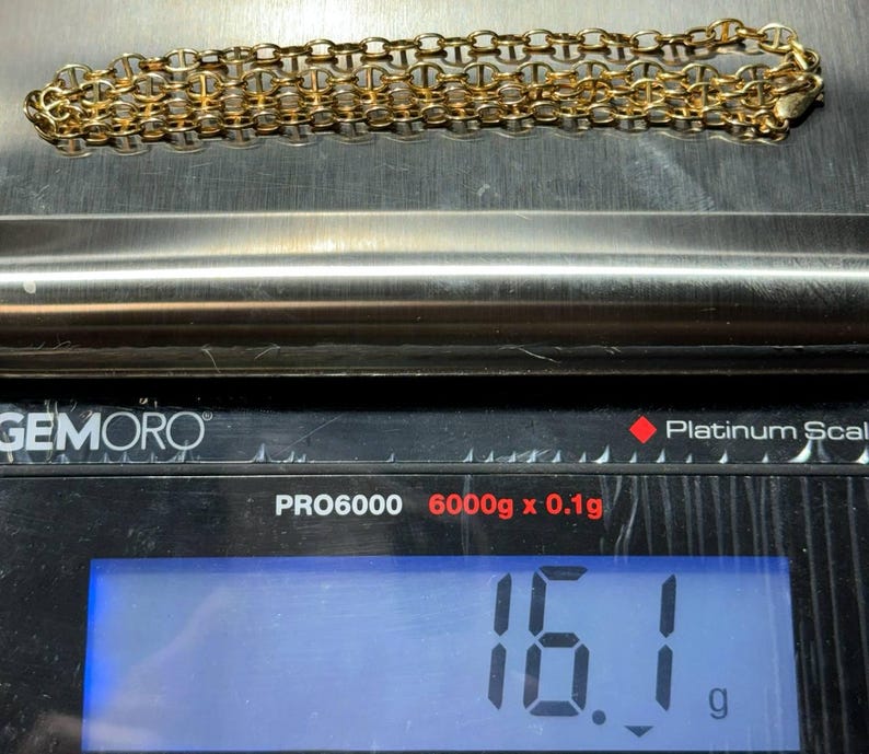 May include: A gold chain necklace weighing 16.1 grams on a digital scale. The scale reads "PRO6000 6000g x 0.1g" and "Platinum Scale".