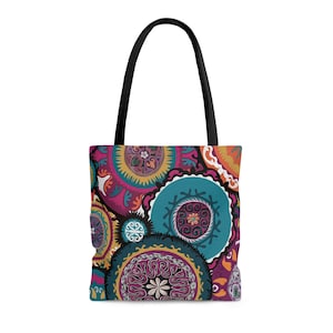 May include: A colorful tote bag with a pattern of overlapping circles in shades of pink, teal, gold, and black. The circles have intricate designs within them.