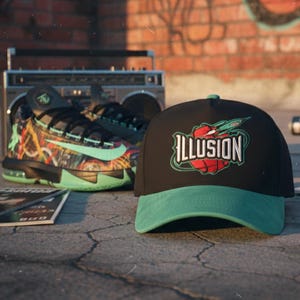 May include: Black baseball cap with a green peak, featuring the word "ILLUSION" in white, and a basketball and rocket ship graphic. Basketball trainers and a boombox are in the background.
