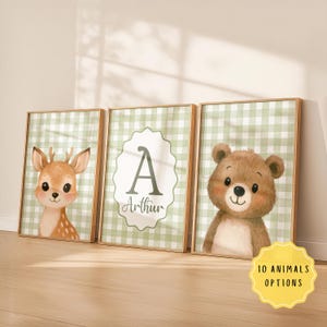 May include: Three framed nursery art prints featuring a deer, a bear, and a monogram with the name "Arthur". The prints have a green and white gingham background. A yellow sticker at the bottom right says "10 ANIMALS OPTIONS".