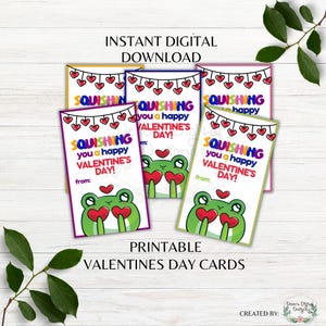 May include: Printable Valentine's Day cards with a frog design. The cards feature the text "Squishing you a happy Valentine's Day!" and are available as an instant digital download. The cards have a colorful design with red hearts.