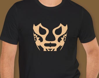May include: Black t-shirt featuring a gold wrestling mask design.