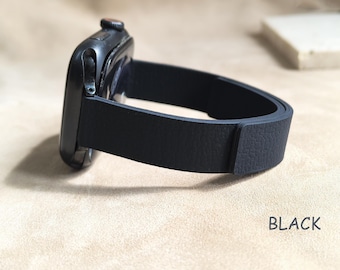 May include: A black smartwatch with a matching black leather band. The band is a simple, single-piece design. The word "BLACK" is printed in white on the surface.