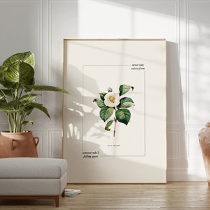 以下が含まれることがあります： 白いカメリアの花と緑の葉の植物画の額装。白い背景に「someone told me I falling apart」と「never take advice from someone who's falling apart」のテキストが書かれています。