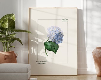 May include: A framed botanical print featuring a blue hydrangea flower with green leaves. The print has the text "when I was dreaming" and "that's when I could finally breathe".