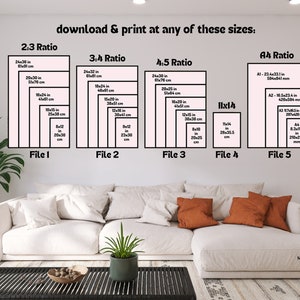 May include: A white couch with orange throw pillows sits in front of a wall with a white background. The wall has a chart with different print sizes for a digital download. The chart includes measurements in inches and centimeters. The text on the chart reads "download & print at any of these sizes: 2:3 Ratio, 3:4 Ratio, 4:5 Ratio, 11x14, A4 Ratio".