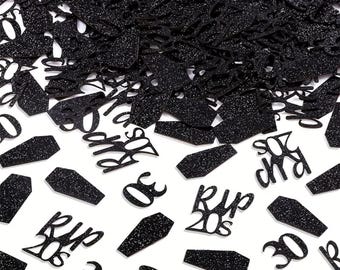 May include: Black glitter confetti with coffin shapes, the number 30, and the text "RIP 20s". The confetti is scattered on a white surface. Ideal for a 30th birthday or a themed party.