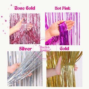 May include: Four different colors of metallic fringe curtains. The colors are rose gold, hot pink, silver, and gold. Each color is held in a hand to show the texture and shine of the material.