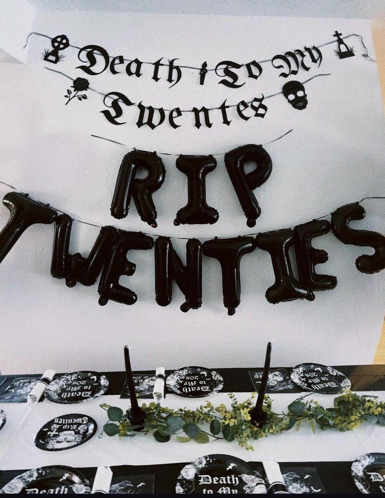 May include: Black and white party decorations with the text "Death to My Twenties" and "RIP Twenties". The decorations include a banner, balloons, and plates.