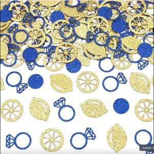 May include: A collection of gold glitter lemon slices, blue glitter circles, and blue glitter diamond ring cutouts on a white background. The confetti is suitable for a wedding or party.