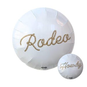 May include: White foil balloon with the word "Rodeo" in gold rope lettering. A smaller balloon with the word "Howdy" is also visible. Both balloons are round and have the brand name "mingle" printed on them.