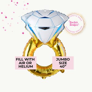 May include: A jumbo-sized diamond ring balloon, 40 inches in size, with a white and blue diamond and a gold ring. The balloon is designed to be filled with air or helium. Text on the balloon reads "Fill with air or helium" and "Jumbo Size 40".
