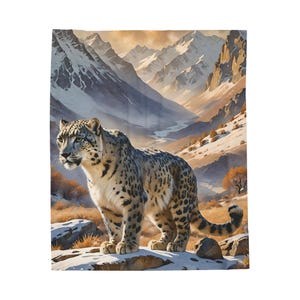 May include: A snow leopard stands on a rocky outcropping in a snowy mountain valley. The leopard is facing to the left and has a light brown and black spotted coat. The background is a snowy mountain range with a blue sky.