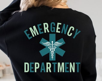 May include: Black sweatshirt with the words "EMERGENCY DEPARTMENT" in teal and light green. A teal medical symbol is centered between the words. The text "Black only" and "FRONT:" are at the bottom of the image.