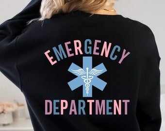 May include: Black sweatshirt with the words "EMERGENCY DEPARTMENT" in pink and blue lettering. A light blue star of life symbol is centered between the words. The word "FRONT:" is printed at the bottom of the sweatshirt.