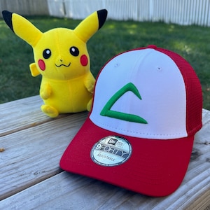 May include: A red and white baseball cap with a green embroidered logo. The logo is a stylized letter C. The cap is a New Era 9FORTY adjustable cap.
