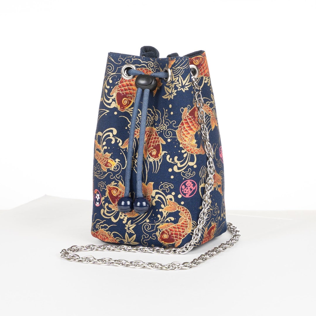 DRAWSTRING BUCKET BAG WITH BEADED HANDLE A PAINTED VILLAGE