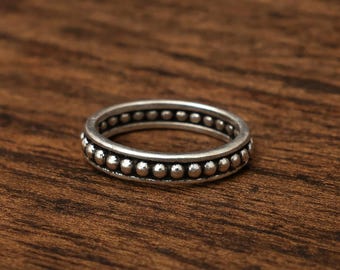 The Oxidized Silver Beaded Ring features a continuous band encircled by a row of small, uniform silver spheres, Christmas gift