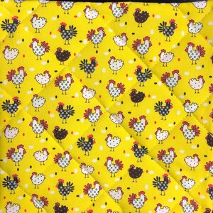May include: Yellow quilted fabric with a repeating pattern of chickens in black, white, and red. The chickens are interspersed with small white and black dots. The fabric has a diamond-shaped quilted design.