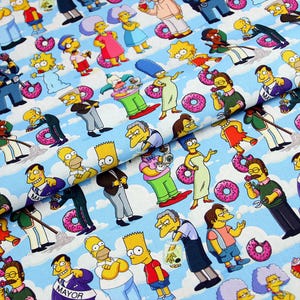 May include: Fabric featuring a repeating pattern of cartoon characters, including Homer, Marge, Bart, Lisa, and Maggie Simpson, along with pink donuts. The background is a light blue with white cloud and stripe designs.