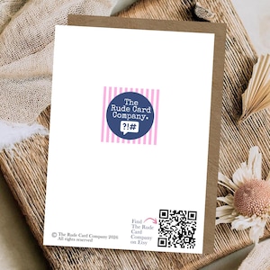 May include: A white greeting card back featuring a central dark blue circular logo with the text The Rude Card Company and symbols ?!#. Below is a black QR code with the text Find The Rude Card Company on Etsy and a copyright notice.