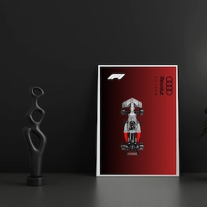 Könnte beinhalten: Ein rechteckiges Poster mit einer Draufsicht auf einen silbernen und roten Formel-1-Rennwagen, der auf einem rot-schwarzen Farbverlaufshintergrund zentriert ist. Das weiße F1-Logo und das schwarze Audi-Vier-Ringe-Logo sind mit dem Text Revolut F1 Team zu sehen.
