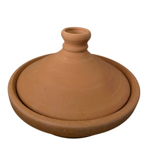 May include: A terracotta tagine with a round base and a domed lid with a small knob on top.