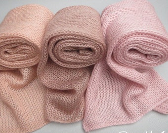 May include: Set of three knitted scarves in shades of pink, peach, and light pink. The scarves are rolled up and arranged in a row. The text "Set #1" is written below the scarves.